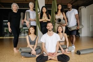 Smiling diverse group practicing yoga in a studio setting with positive energy.